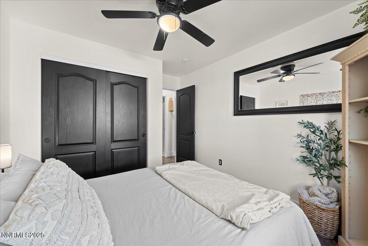 17675 Alexandria Court Reno, NV 89508 - Photo 12 of 31 a bedroom with a bed and a chandelier