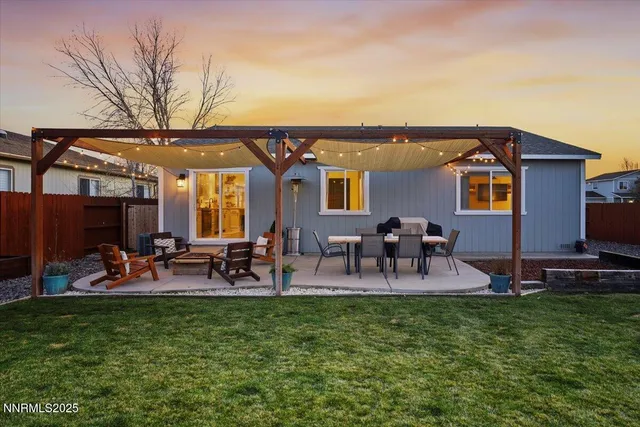 a view of a house with patio and a yard
