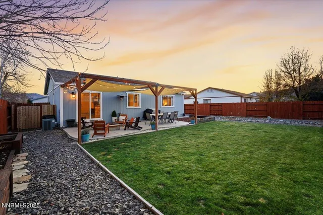 a view of a house with backyard porch and sitting area