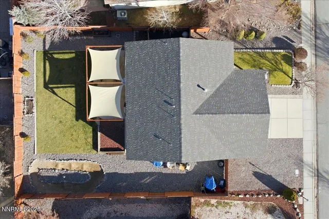 an aerial view of a house with a yard