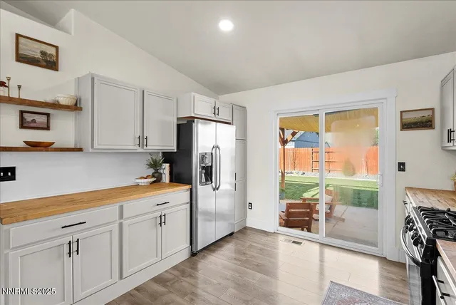 a kitchen with stainless steel appliances a refrigerator sink and cabinets
