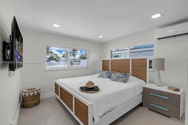 a bedroom with a bed and a flat screen tv