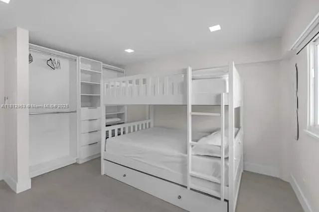 a walk in closet with white walls