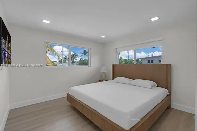 a large white bed in a white room