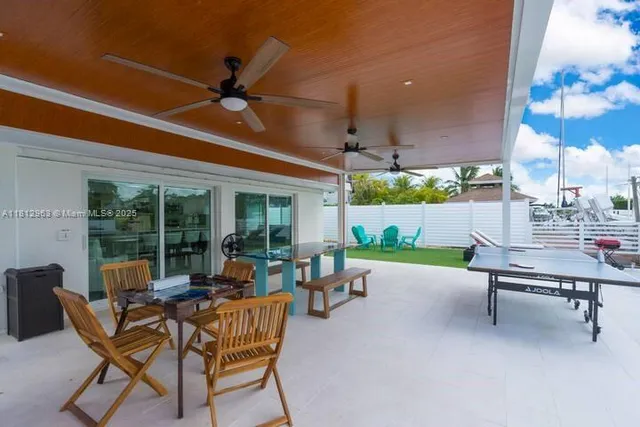 a view of a patio with table and chairs