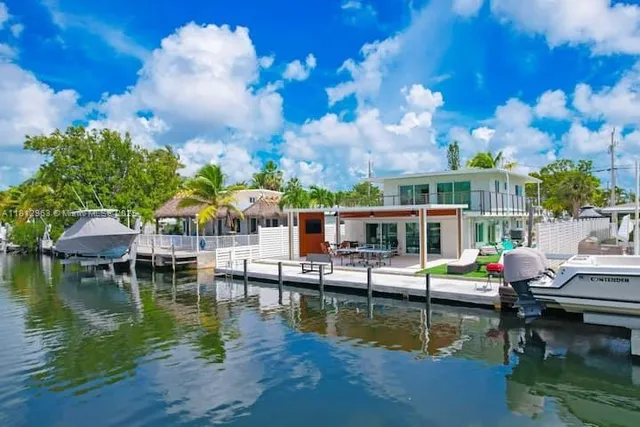 a view of house with swimming pool and outdoor seating