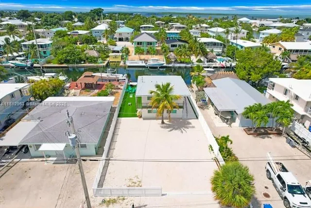 an aerial view of a house with a ocean view