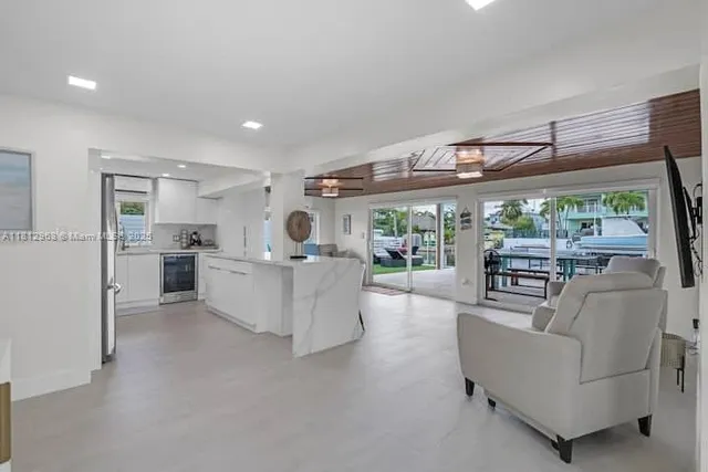 a living room with furniture and a large window