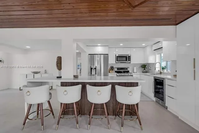 a kitchen with stainless steel appliances kitchen island granite countertop a sink and cabinets
