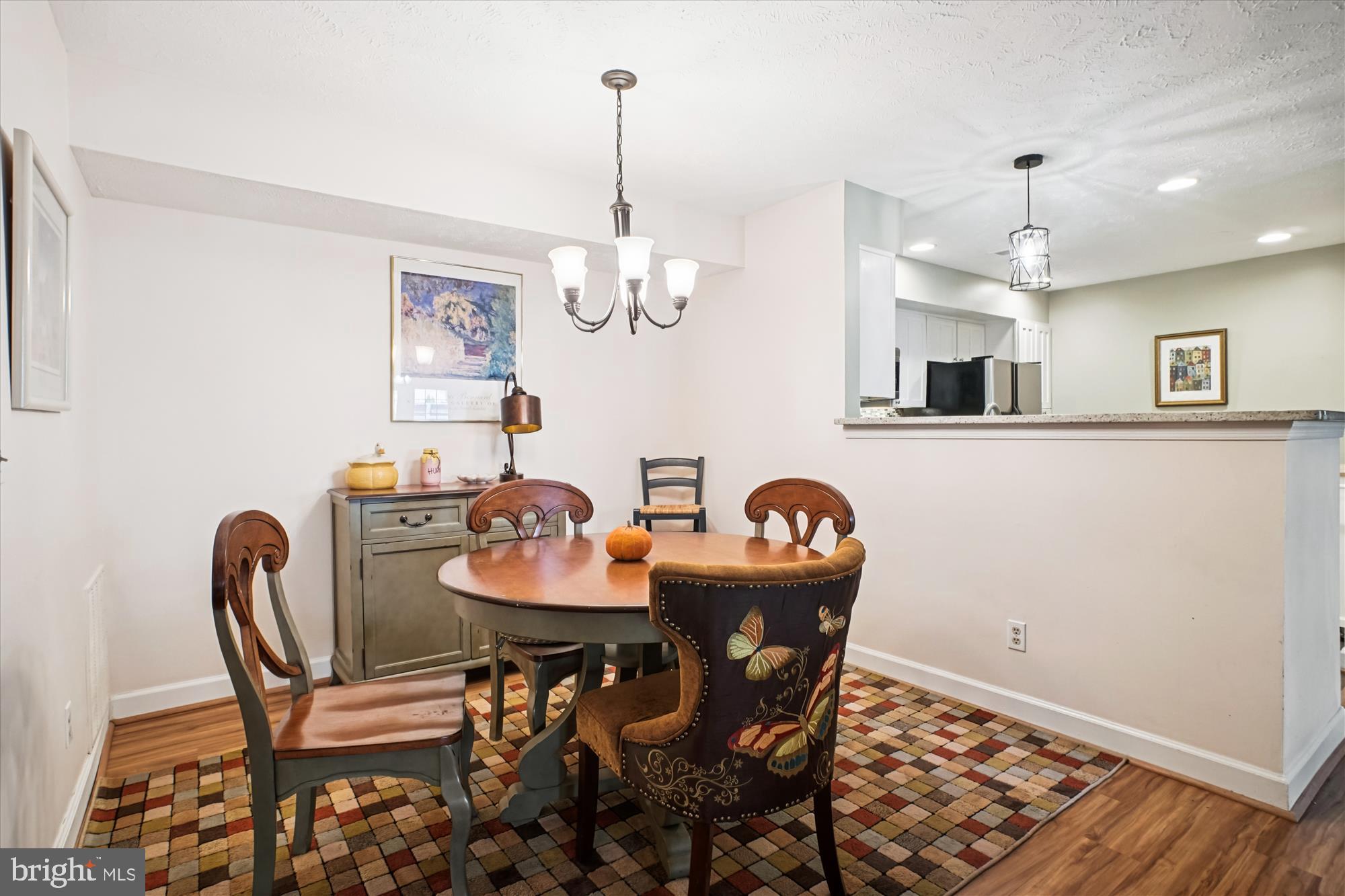 3801 Ridge Knoll Court, Unit 2A Fairfax, VA 22033 - Photo 10 of 37 a dining room with furniture a chandelier and wooden floor
