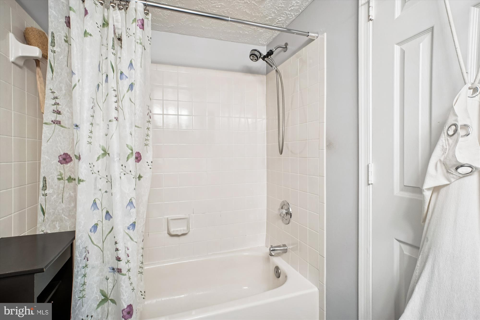 3801 Ridge Knoll Court, Unit 2A Fairfax, VA 22033 - Photo 16 of 37 a bathroom with a shower curtain and a bathtub