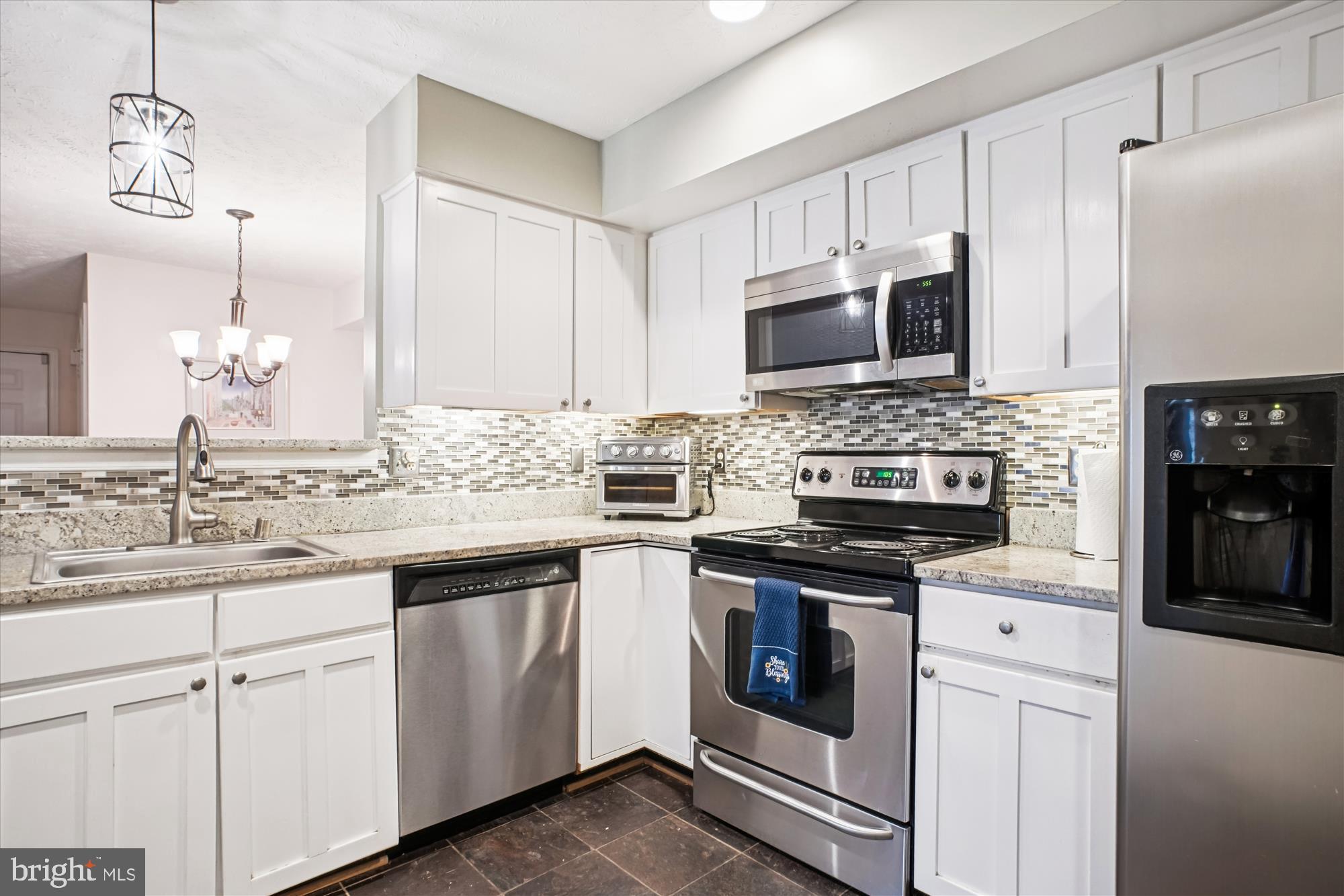 3801 Ridge Knoll Court, Unit 2A Fairfax, VA 22033 - Photo 3 of 37 a kitchen with granite countertop white cabinets sink and stainless steel appliances