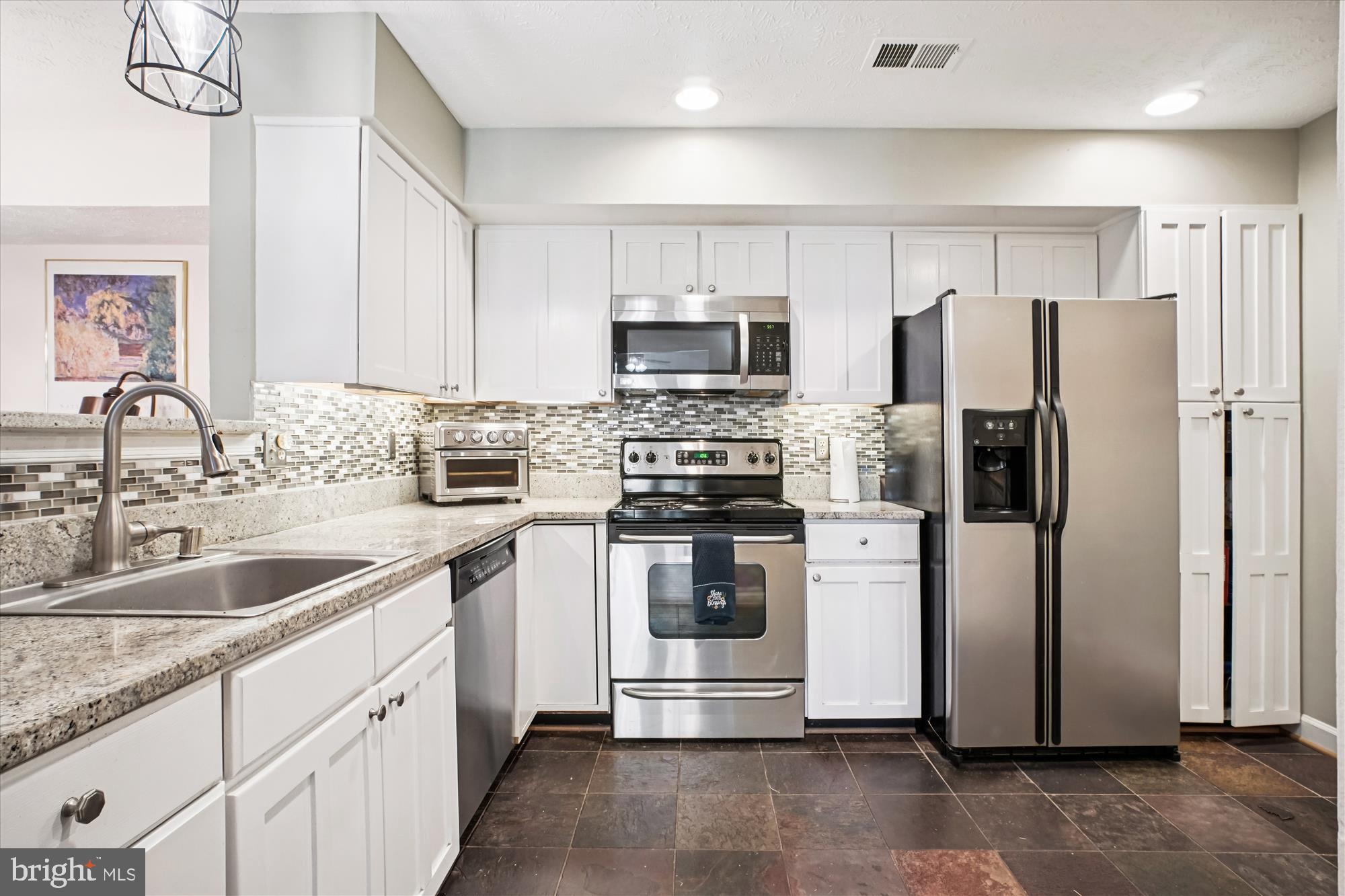 3801 Ridge Knoll Court, Unit 2A Fairfax, VA 22033 - Photo 4 of 37 a kitchen with stainless steel appliances granite countertop a refrigerator a stove a sink and a microwave