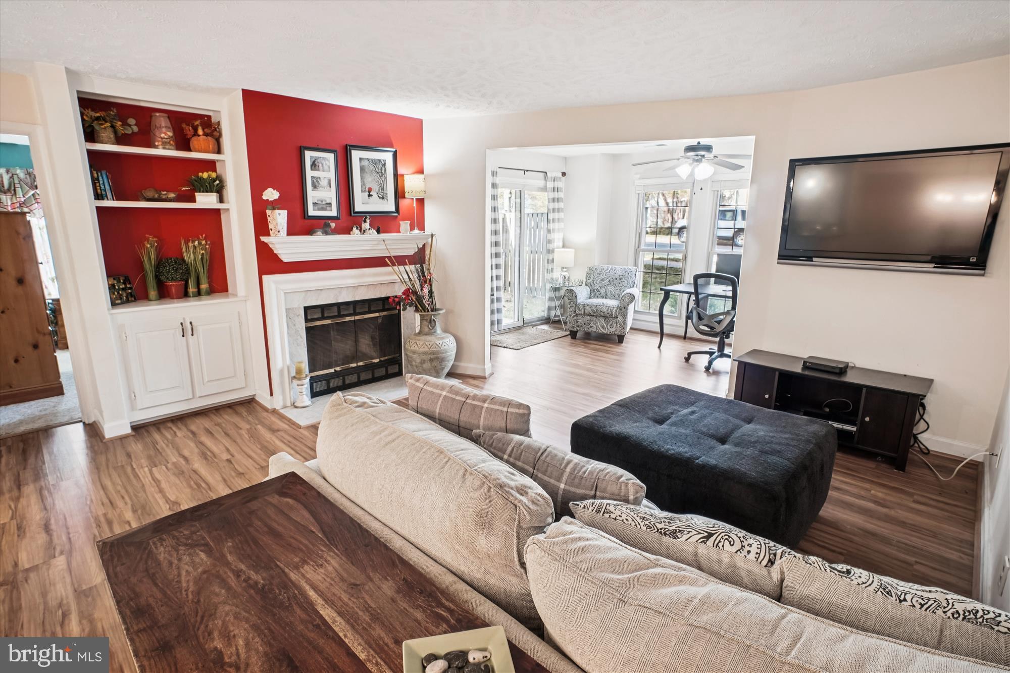 3801 Ridge Knoll Court, Unit 2A Fairfax, VA 22033 - Photo 9 of 37 a living room with furniture a flat screen tv and a fireplace