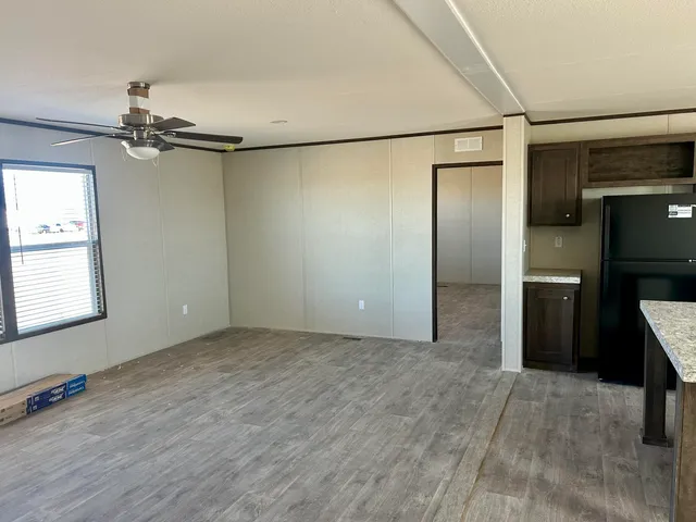 an empty room with windows and entrance