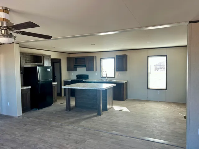 a large kitchen with a table and chairs