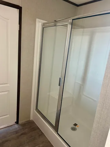 a bathroom with a glass door shower