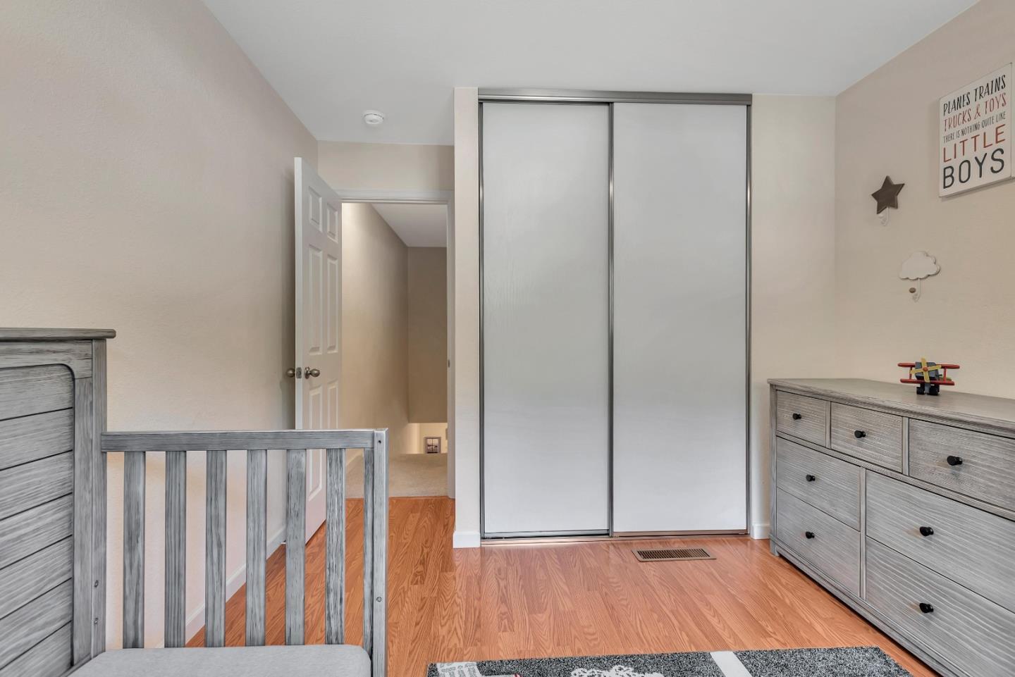 1377 Lerida Way Pacifica, CA 94044 - Photo 16 of 25 a view of a bedroom with wooden floor and cabinet