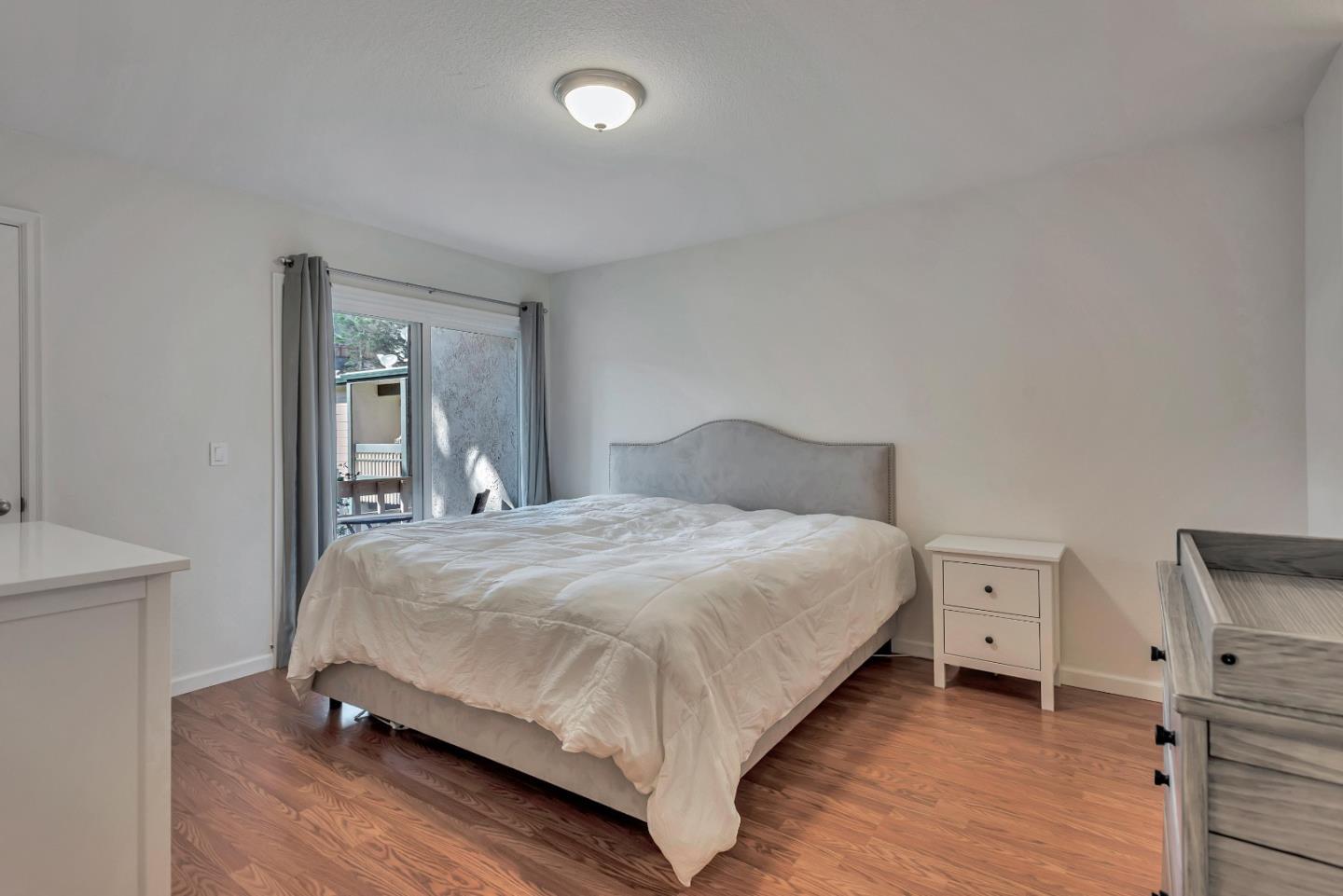 1377 Lerida Way Pacifica, CA 94044 - Photo 17 of 25 a bedroom with a bed and a night stand