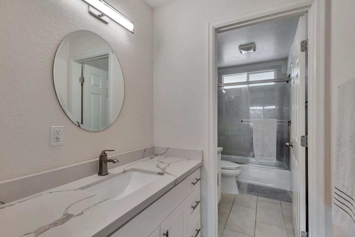 1377 Lerida Way Pacifica, CA 94044 - Photo 21 of 25 a bathroom with a granite countertop sink a mirror and a vanity