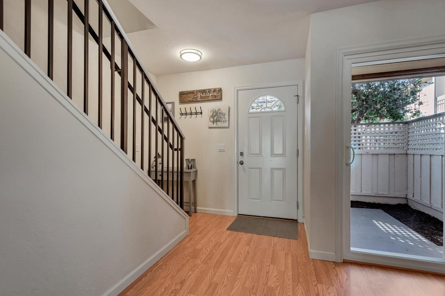 1377 Lerida Way Pacifica, CA 94044 - Photo 3 of 25 a view of a hallway with wooden floor and stairs