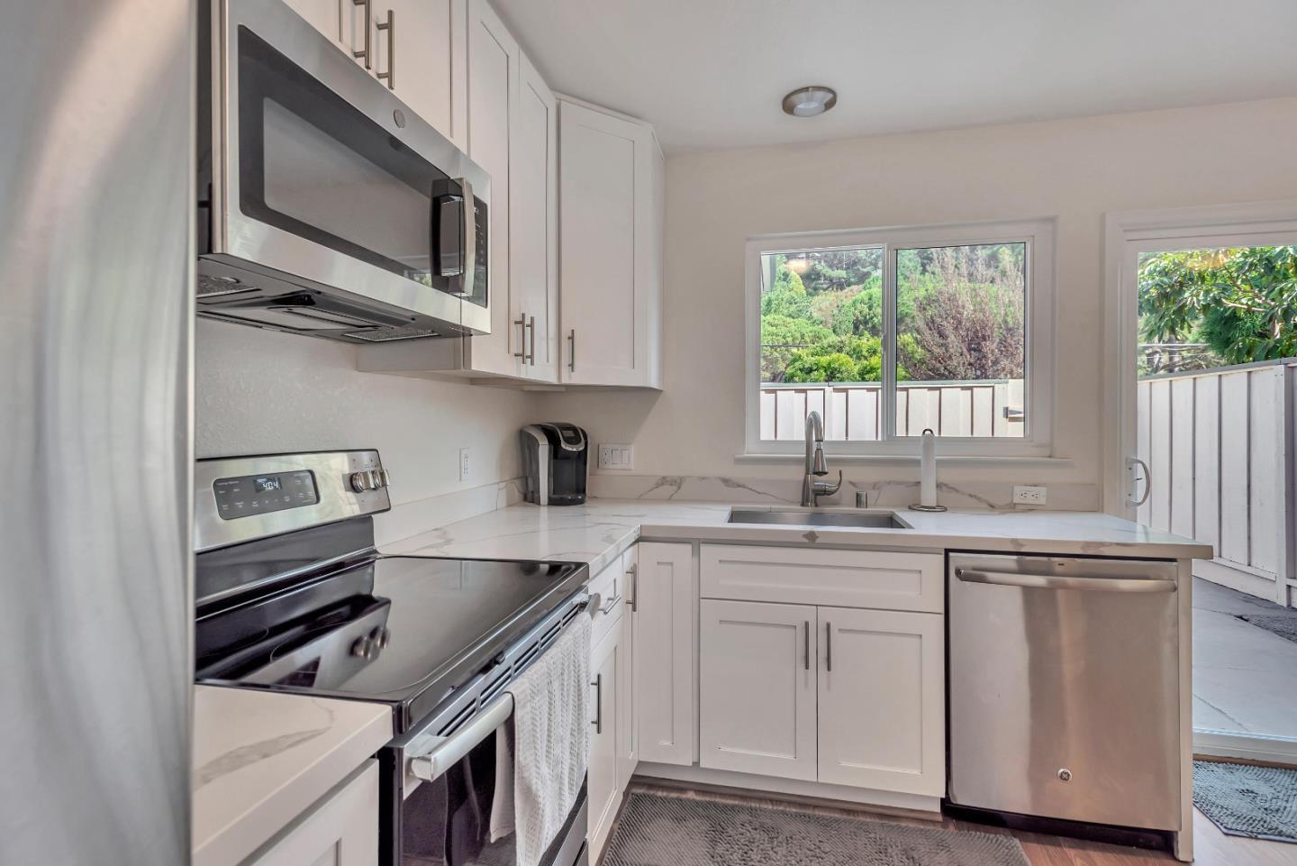 1377 Lerida Way Pacifica, CA 94044 - Photo 10 of 25 a kitchen with stainless steel appliances granite countertop a sink and cabinets
