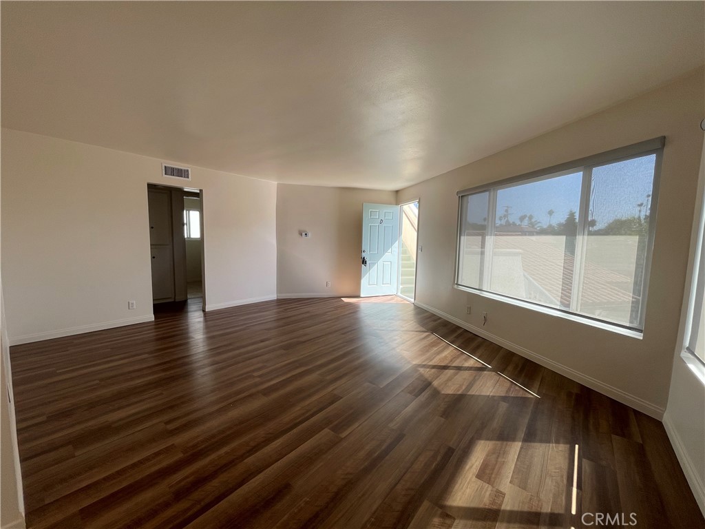 258 Avenida Victoria, Unit D San Clemente, CA 92672 - Photo 5 of 12 wooden floor in an empty room with a window