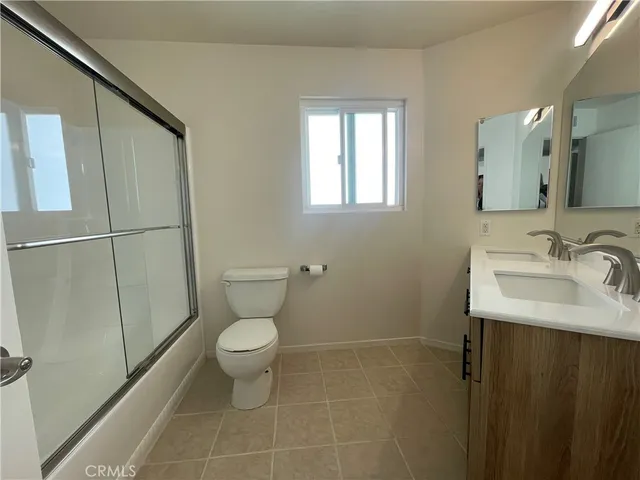 a bathroom with a sink toilet and a mirror