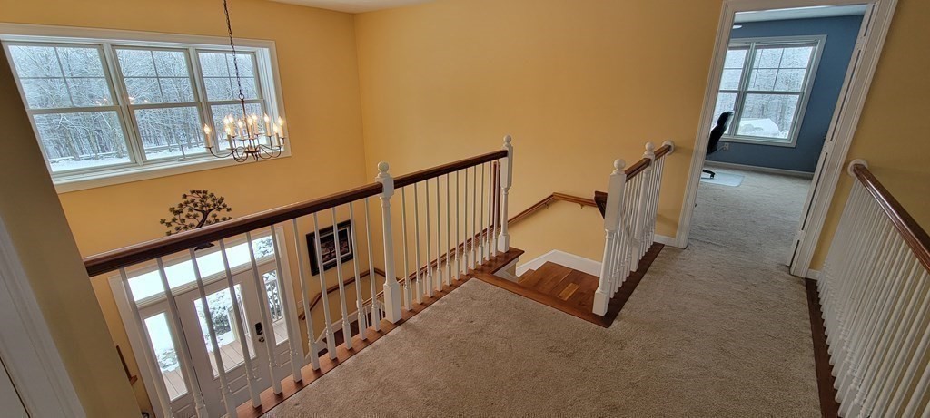 358 Rutherford Road Oakham, MA 01068 - Photo 15 of 42 a view of staircase with lots of frames on wall and windows
