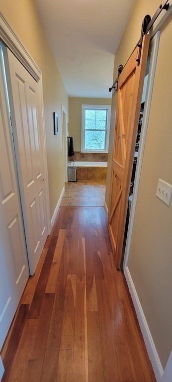 358 Rutherford Road Oakham, MA 01068 - Photo 19 of 42 a view of a hallway with wooden floor and staircase