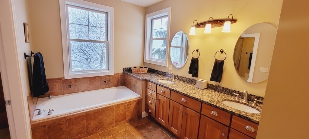358 Rutherford Road Oakham, MA 01068 - Photo 20 of 42 a bathroom with a granite countertop tub sink and mirror