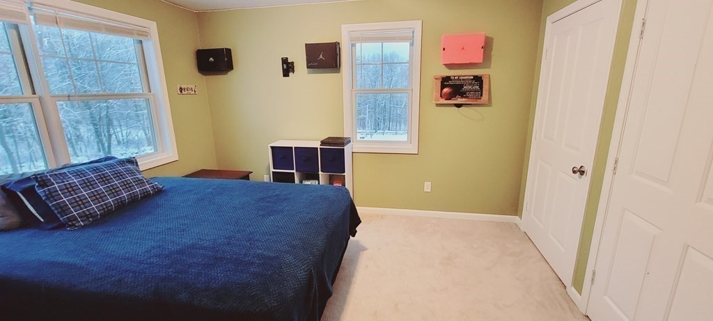 358 Rutherford Road Oakham, MA 01068 - Photo 24 of 42 a bedroom with a bed and wooden floor