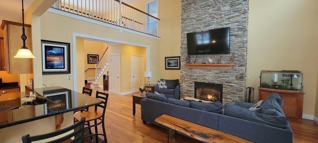 358 Rutherford Road Oakham, MA 01068 - Photo 9 of 42 a living room with furniture and a fireplace