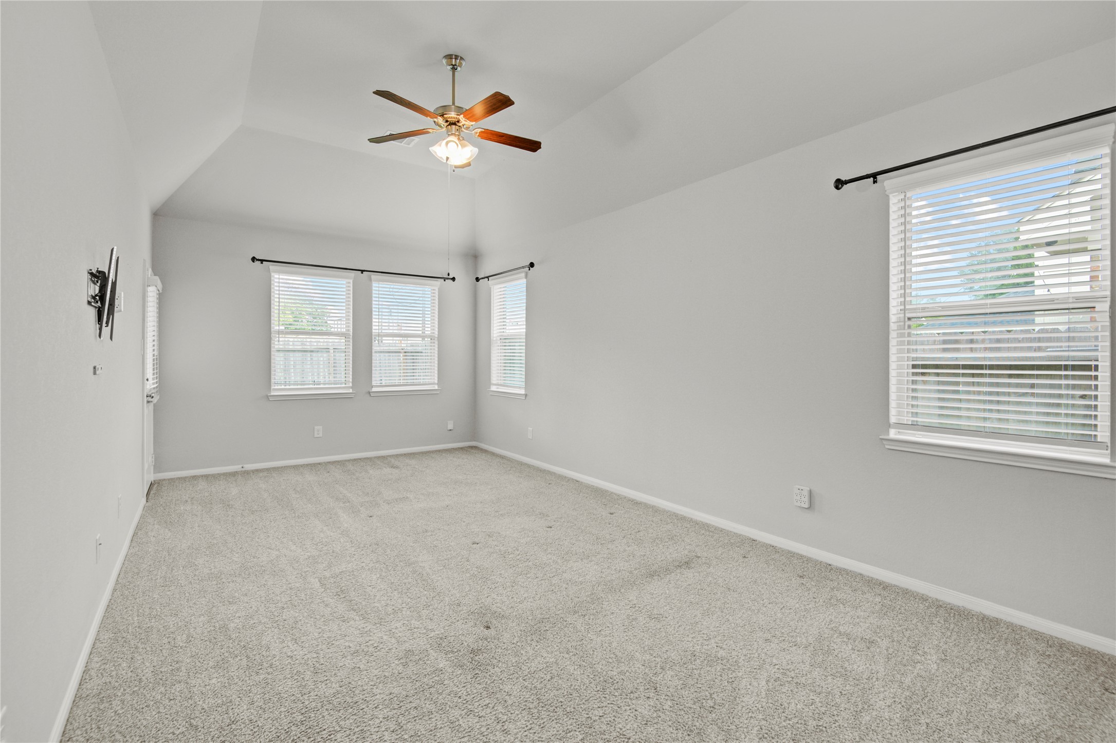 1314 Orchard Ridge Lane Tomball, TX 77375 - Photo 20 of 35 The spacious primary bedroom features soft natural light and a calm, neutral palette for a relaxing retreat.