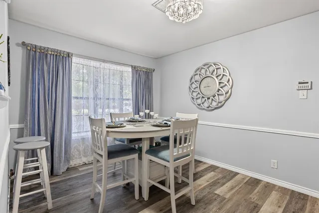 a view of a dining room with furniture and wooden floor
