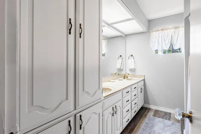 a bathroom with a double vanity sink and mirror