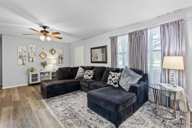 a living room with furniture and a large window