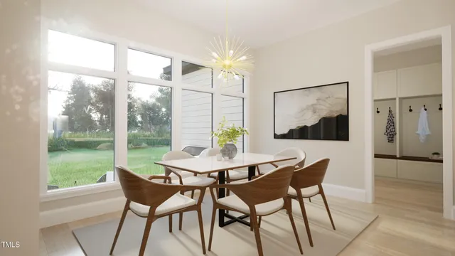 a kitchen with a dining table chairs and refrigerator