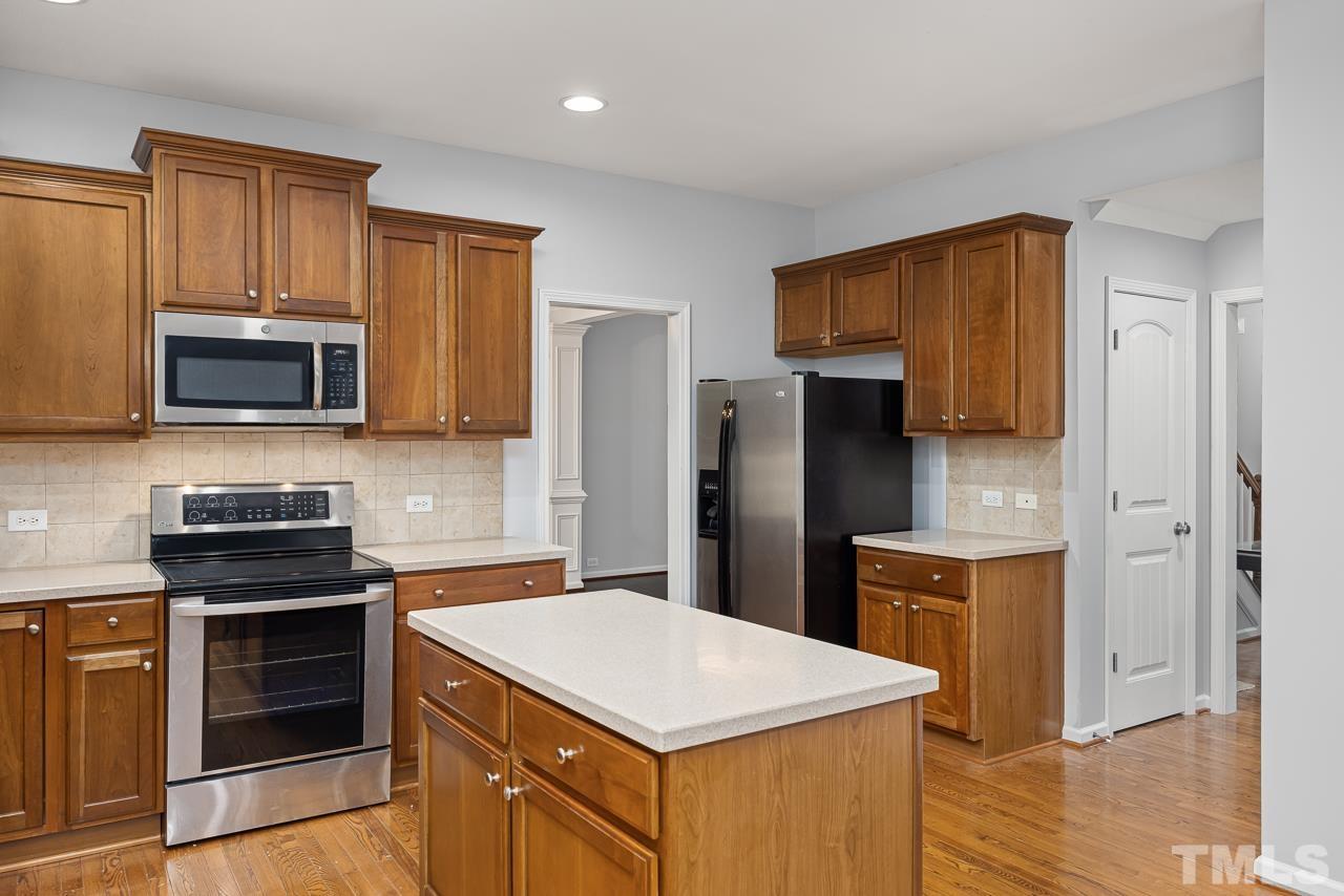 4506 Paces Ferry Drive Durham, NC 27712 - Photo 12 of 38 a kitchen with stainless steel appliances a refrigerator stove and microwave