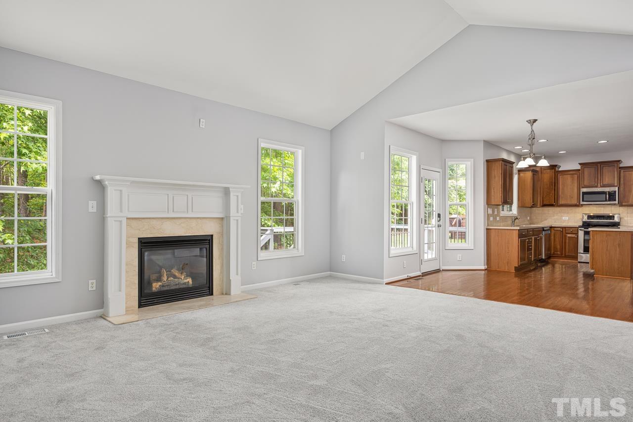 4506 Paces Ferry Drive Durham, NC 27712 - Photo 14 of 38 an empty room with furniture and a fireplace