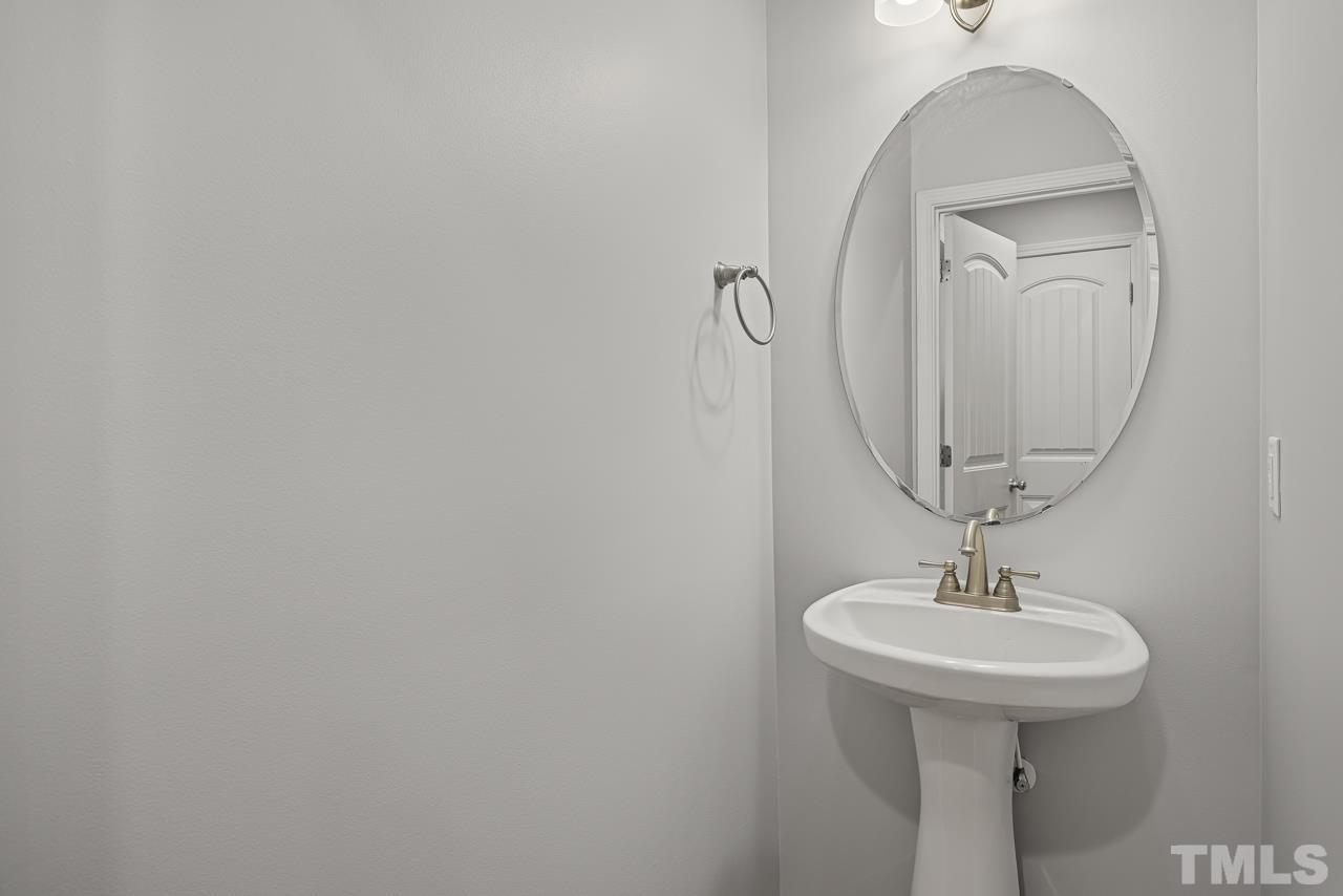 4506 Paces Ferry Drive Durham, NC 27712 - Photo 17 of 38 a bathroom with a sink and mirror