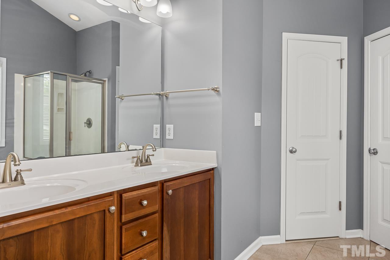 4506 Paces Ferry Drive Durham, NC 27712 - Photo 22 of 38 a bathroom with a sink vanity and a mirror