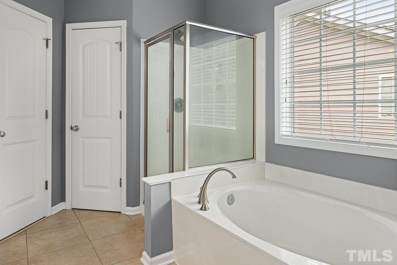 4506 Paces Ferry Drive Durham, NC 27712 - Photo 23 of 38 a bathroom with a bathtub and a shower