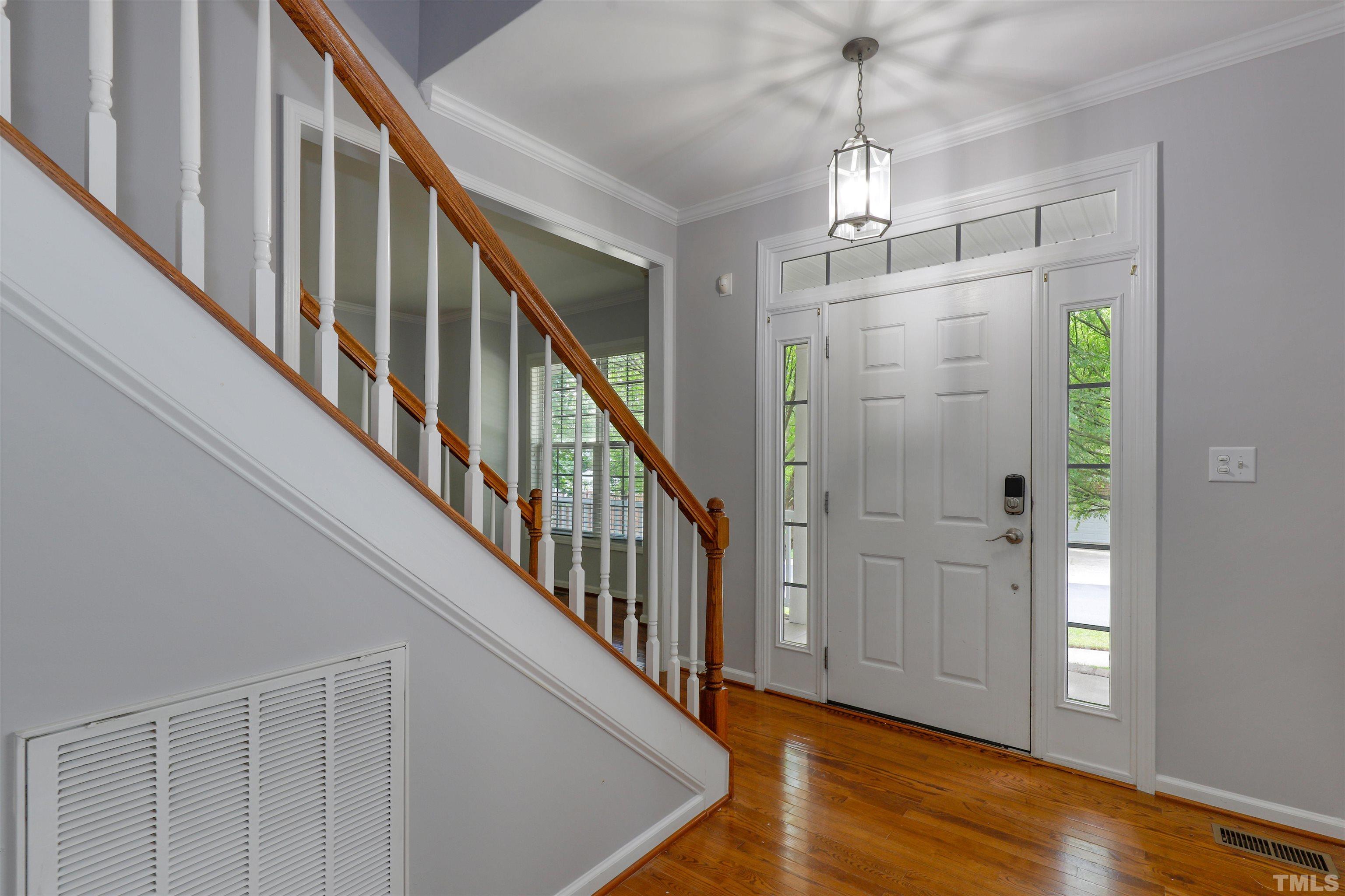 4506 Paces Ferry Drive Durham, NC 27712 - Photo 3 of 38 a view of a hallway with wooden floor and staircase