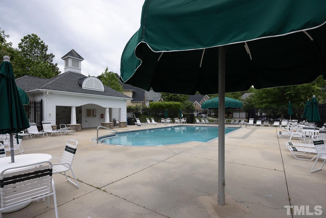 4506 Paces Ferry Drive Durham, NC 27712 - Photo 36 of 38 a view of a patio with a table and chairs under an umbrella
