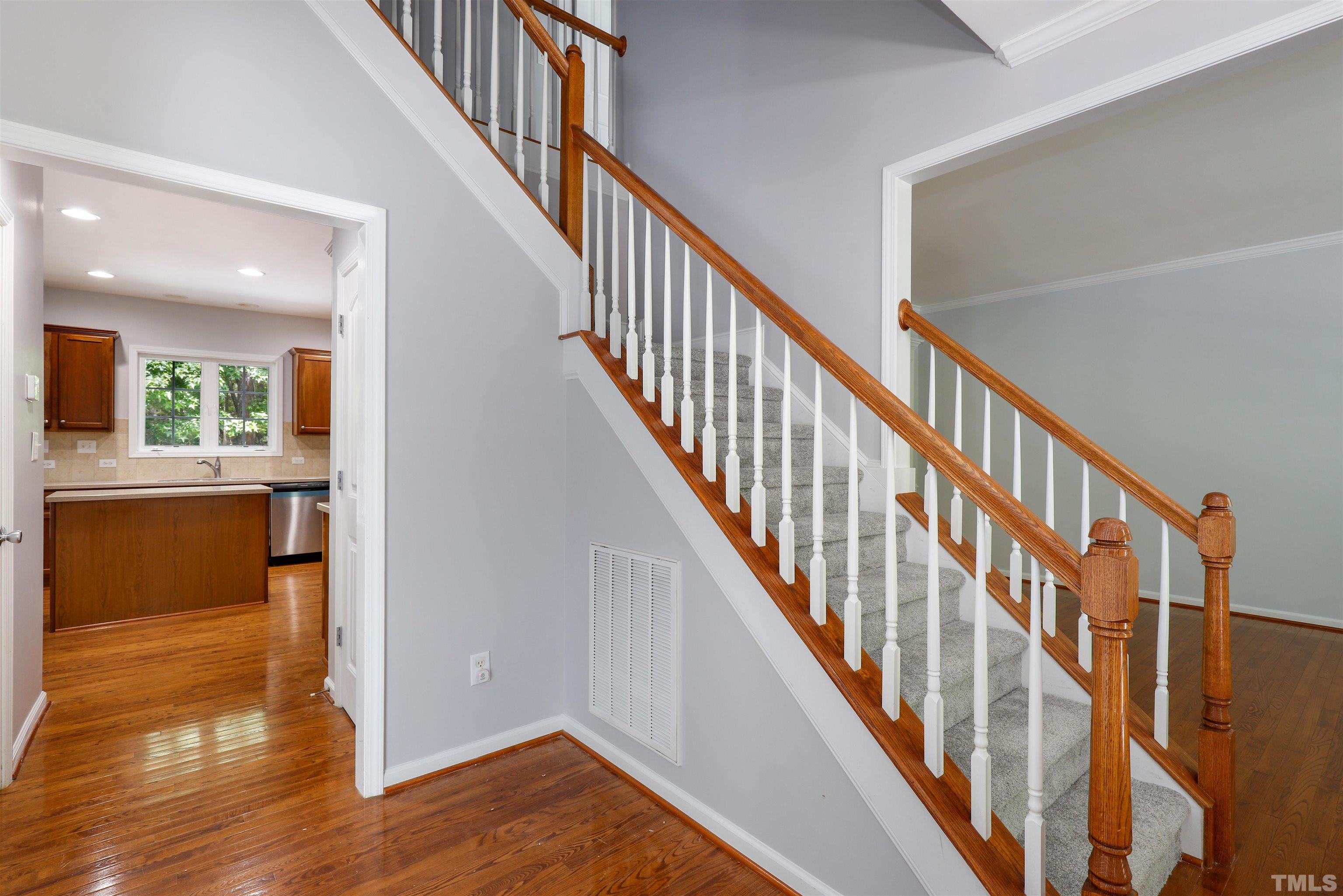 4506 Paces Ferry Drive Durham, NC 27712 - Photo 5 of 38 a view of an entryway with wooden floor and a kitchen view