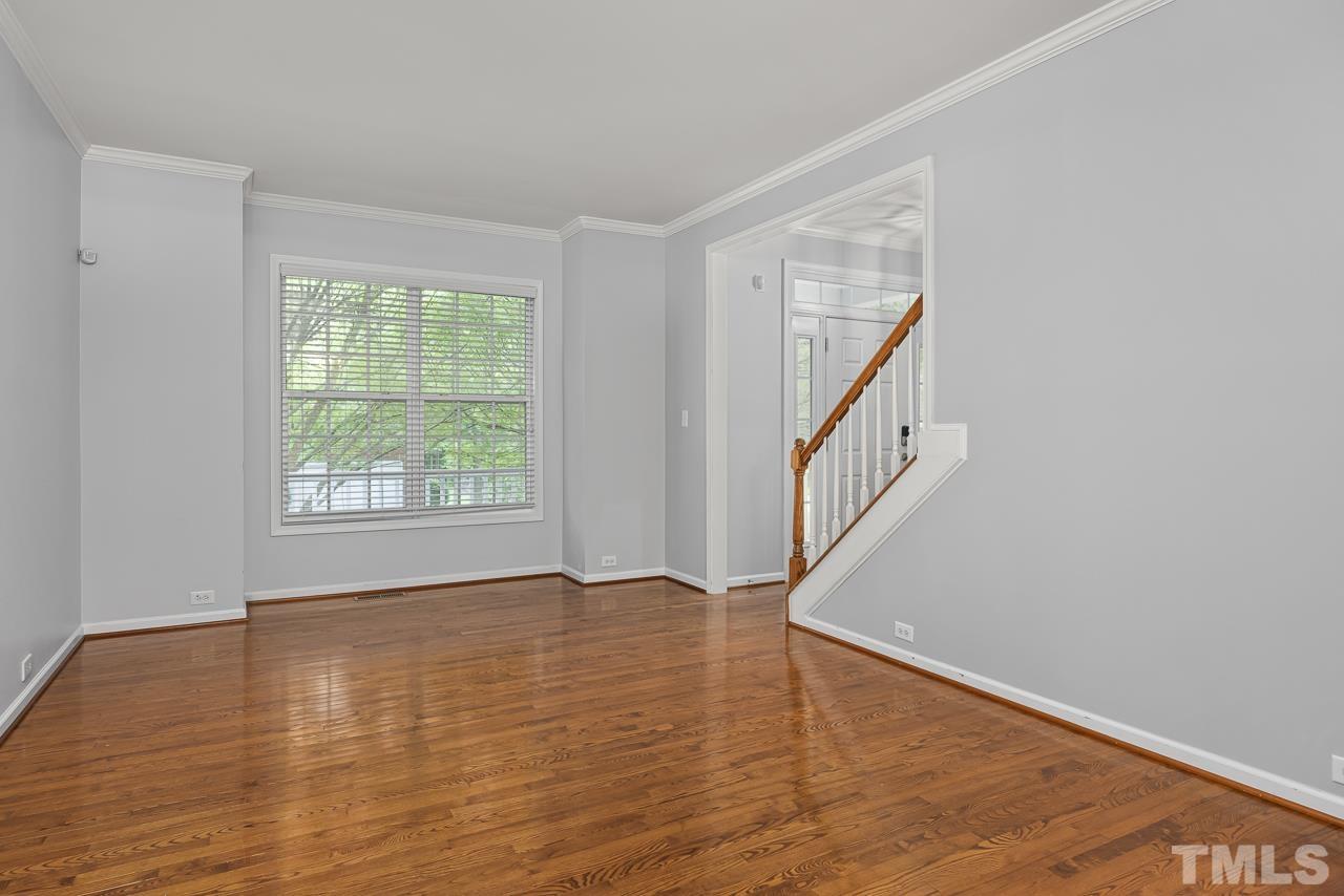 4506 Paces Ferry Drive Durham, NC 27712 - Photo 7 of 38 a view of an empty room with wooden floor and a window