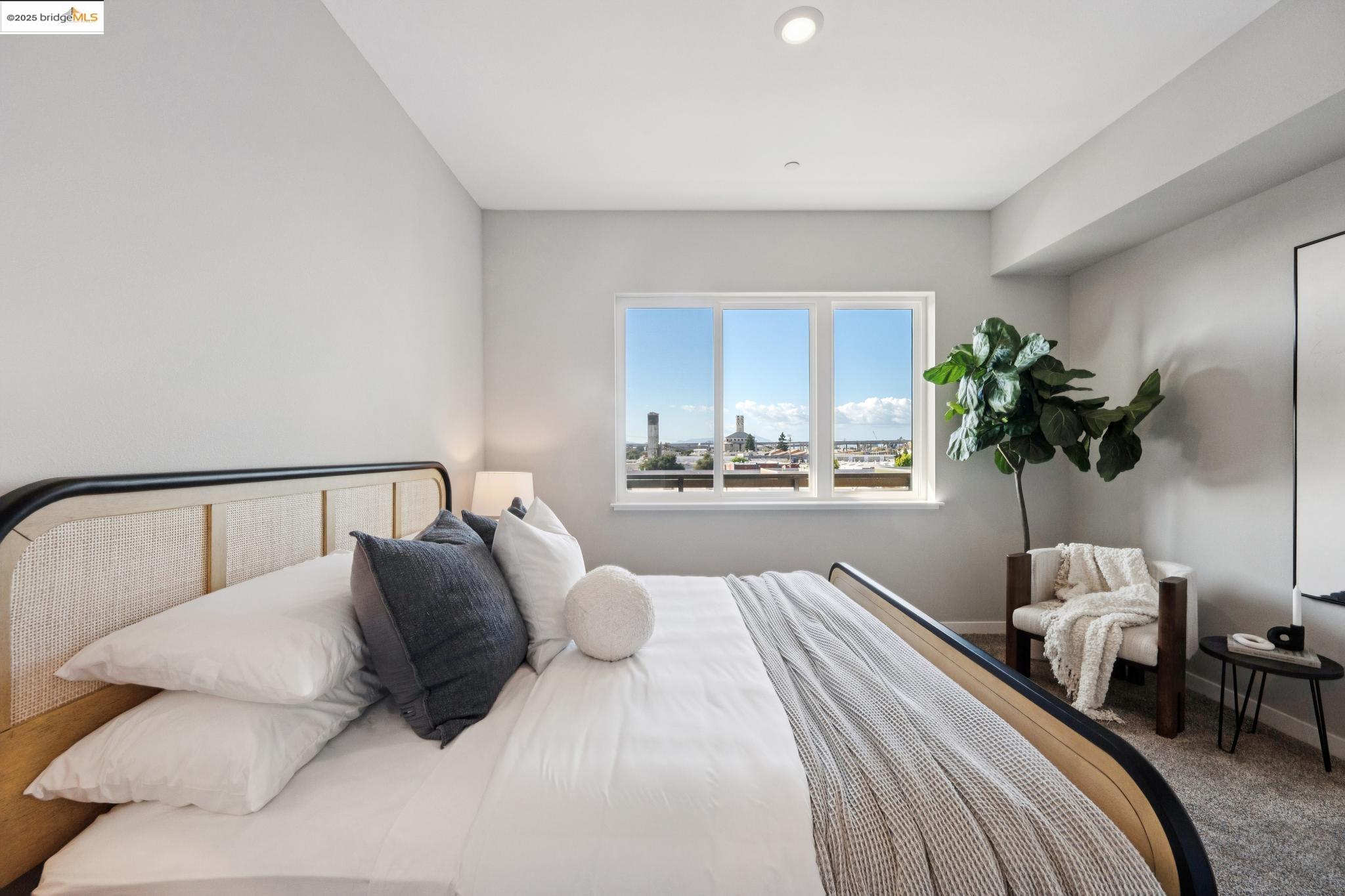 2400 Adeline Street, Unit 403 Oakland, CA 94607 - Photo 13 of 25 a bedroom with a bed and a potted plant