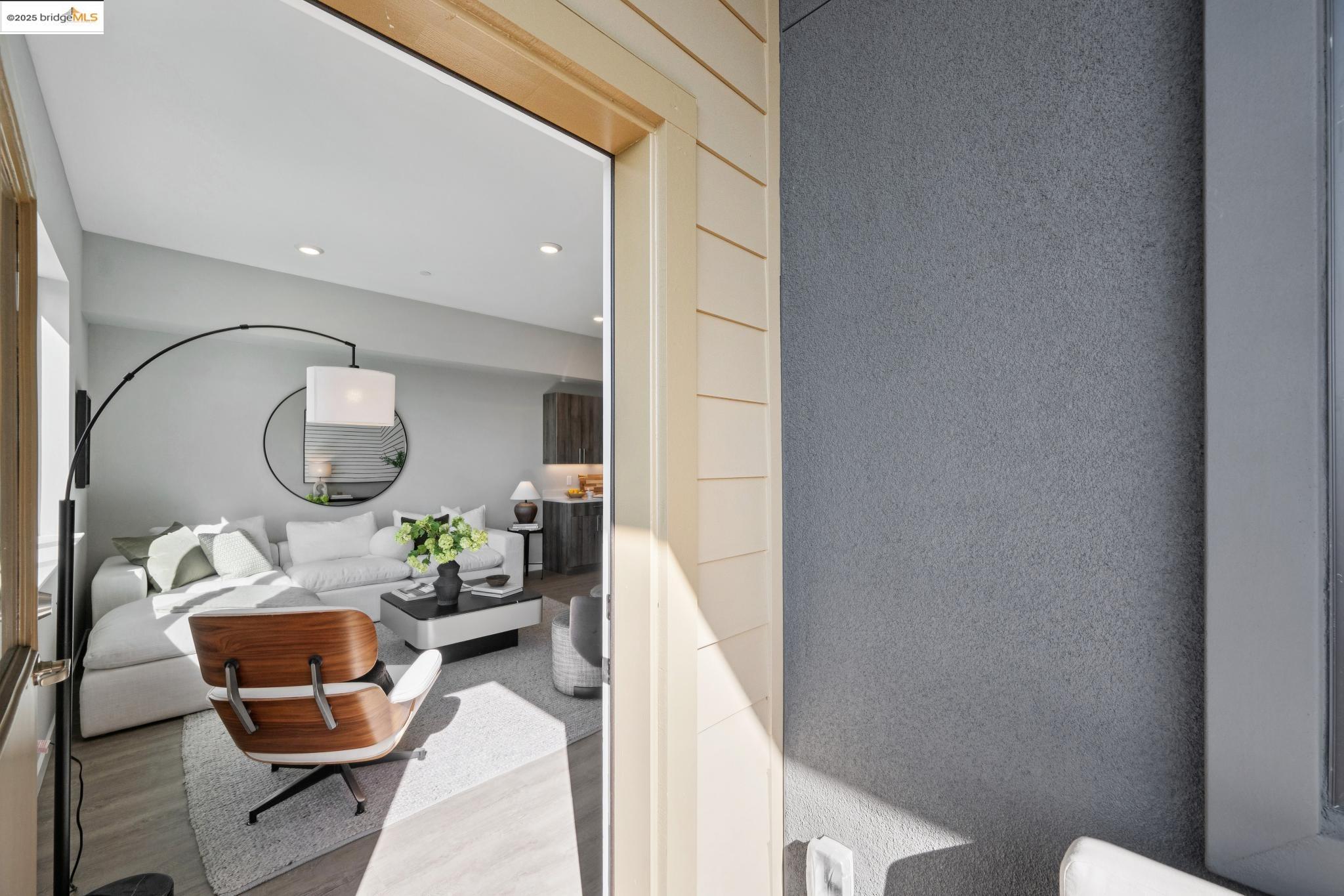 2400 Adeline Street, Unit 403 Oakland, CA 94607 - Photo 16 of 25 a living room with furniture and a mirror