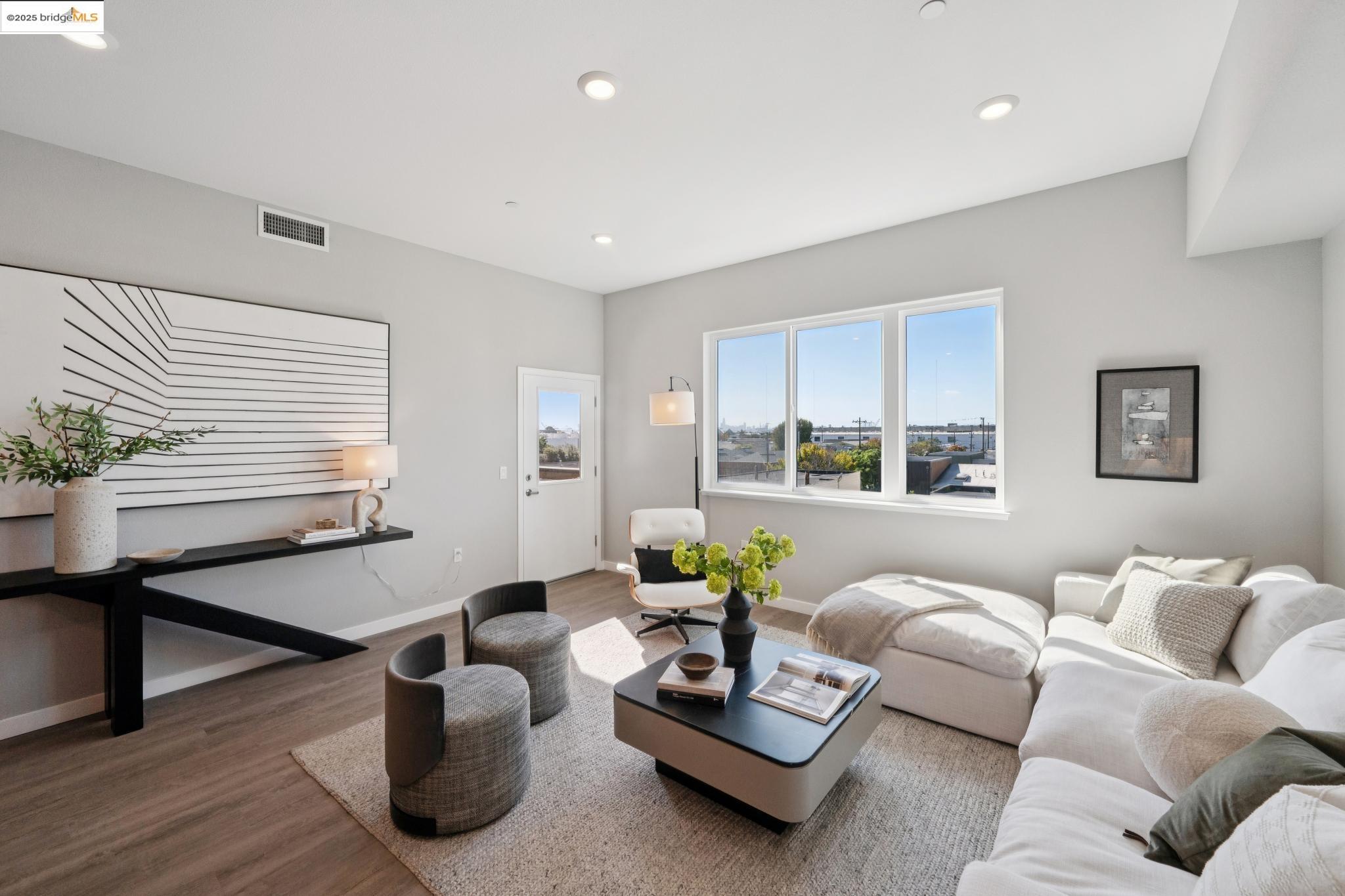 2400 Adeline Street, Unit 403 Oakland, CA 94607 - Photo 7 of 25 a living room with furniture and wooden floor